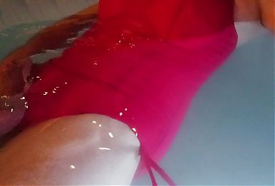 Ladyboy swimming in sexy red swimsuit